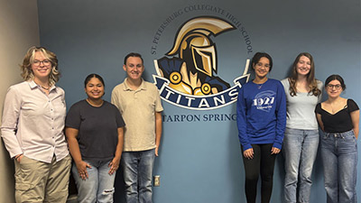 SPC collegiate high school students lined up in front of a blue wall with the SPC logo