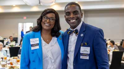 Dr. Williams and Boykins wearing business attire smiling