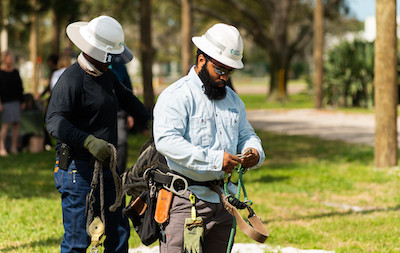 Duke Energy employee demostrating the job of electrical lineworker