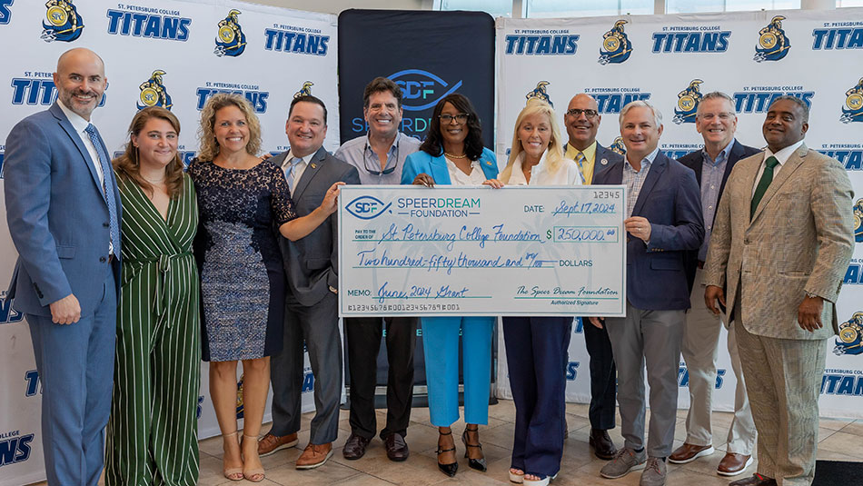 group of 11 people in business attire celebrating scholarship funding