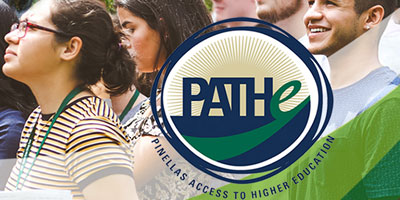 A group of students watching a presentation outdoors.