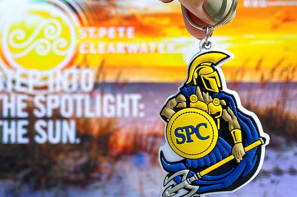 illustration of a beach and logo for Visit St. Pete-Clearwater and a Titus keychain