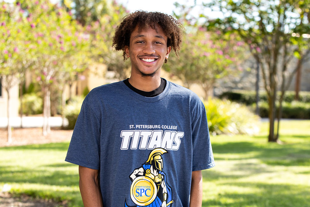 male SPC student smiling wearing a grey Titans tshirt
