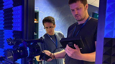 two male students setting up and using a video camera