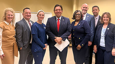 SPC's Board of Trustees members pose with Gov. Ron DeSantis at HEC