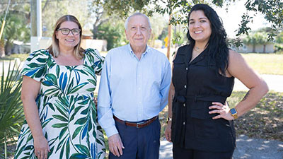 Jose Heinert, center, with Hispanic Outreach Center staff Carolyn Otero Torres, right, and Amanda Markiewicz, left