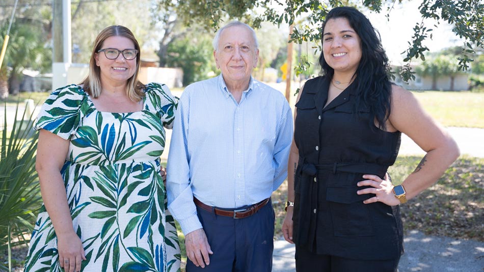 Jose Heinert, center, with Hispanic Outreach Center staff Carolyn Otero Torres, right, and Amanda Markiewicz, left