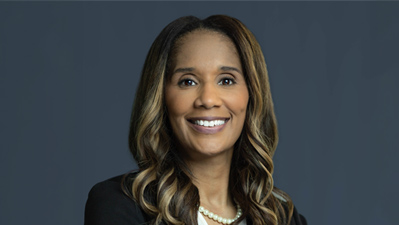 portrait of Raquel Hairston in a black suit and black shirt