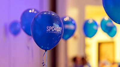 image of blue balloons with the words SPC Day written in white
