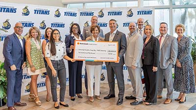 members of Suncoast Credit Union and SPC Foundation posing with a check that was presented