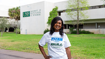 female SPC student wearing a white tshirt with the words Titan today Bull tomorrow