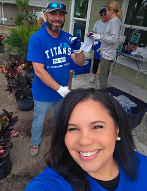 spc employee taking a selfie with other employees in blue titans t shirts