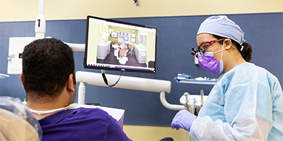 dental hygiene student with a patient in the dentist chair