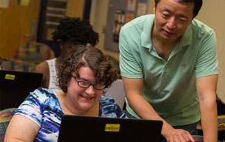 mentor teaching a student in front of a computer