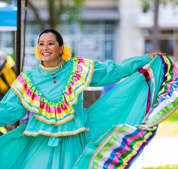 female performer twirling her green dress with her hands