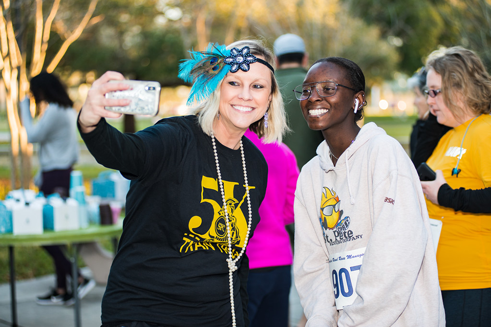 two runners posing for a selfie at the SPC Titan Trot 5K race