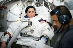 Alumna Nicole Stott participates in an Extravehicular Mobility Unit (EMU) spacesuit fit check