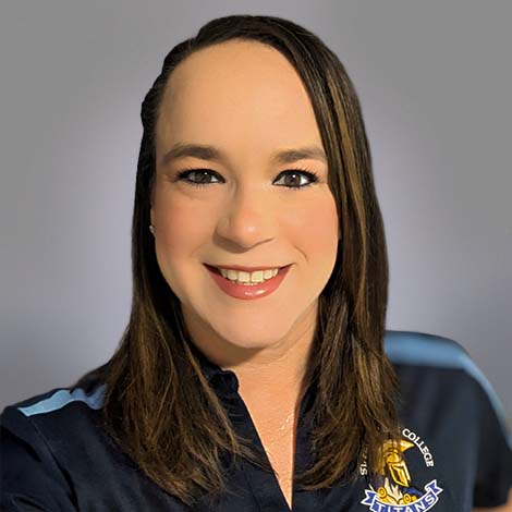A portrait of Annette Vargas, wearing a blue SPC Titans, Seminole Campus, polo shirt.