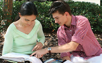 Two students studying outside on campus