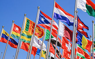 flags from many different countries waving in a strong wind