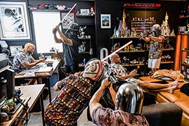 Student digital media project for advanced digital image editing. A man is shown in six different poses in a room packed with nostalgic video game and movie paraphernalia.