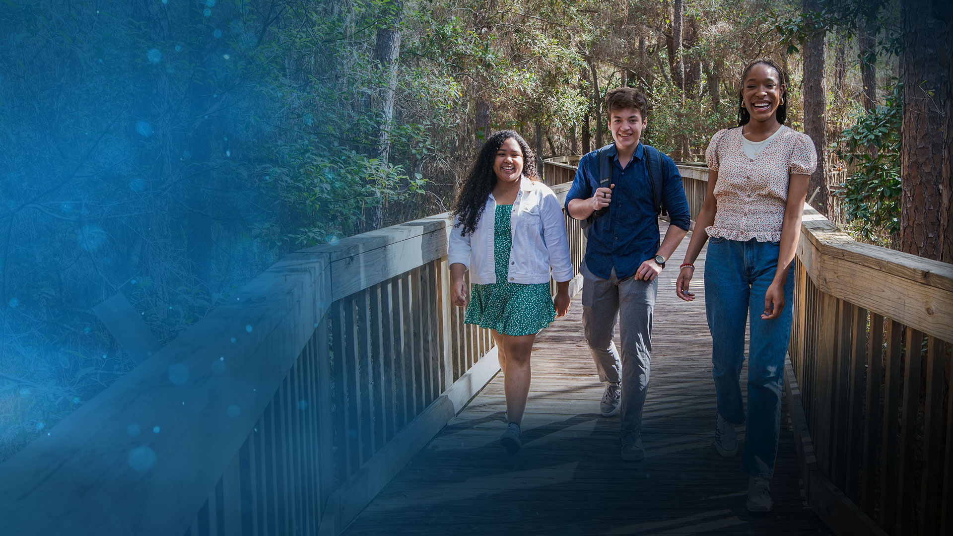 SPC students smiling walking on a boardwalk at the Seminole Campus