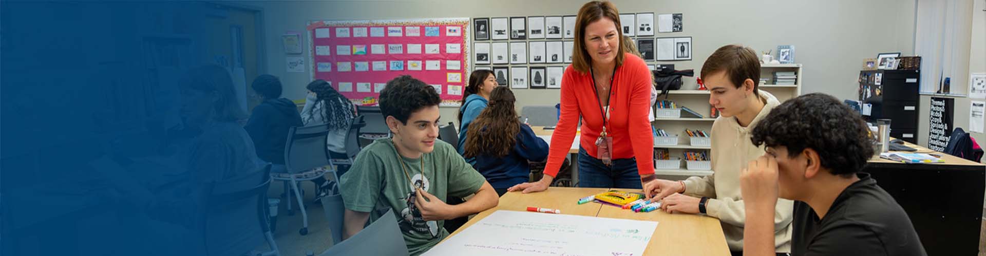 african american woman smiling seated in front of laptop