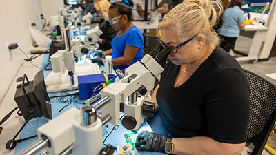 group of women working at soldering stations