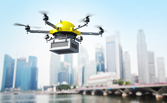 a drone hoveriing with a city skyline in the background