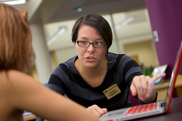 An advisor explaining something to a student.