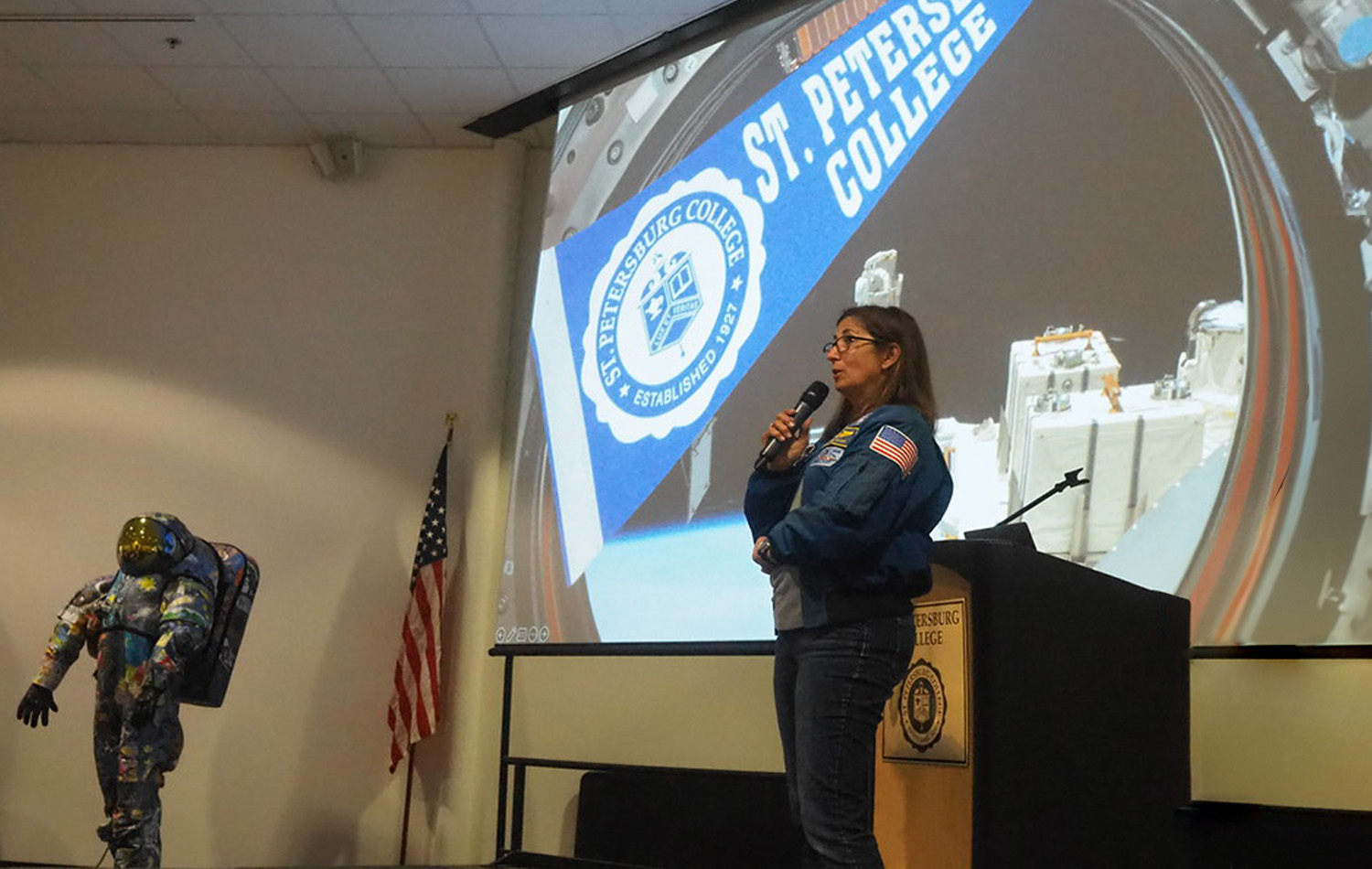 SPC alumni NIcole Scott speaking on a stage