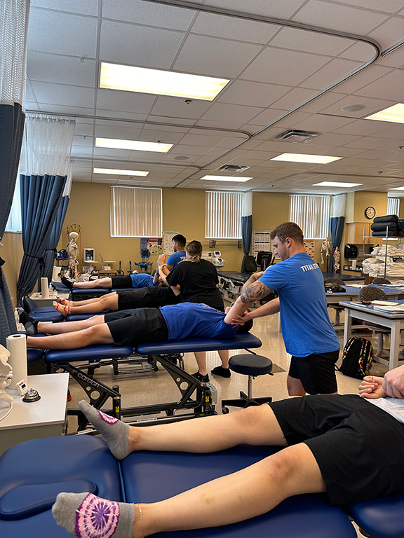 physcial therapy assistant students using their new tables for clinicals