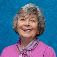 head shot of Phyllis Powell in front of a blue background