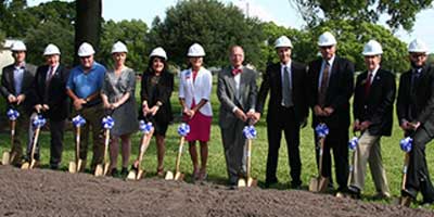 a group of people lined up ready to do a ground breaking ceremony