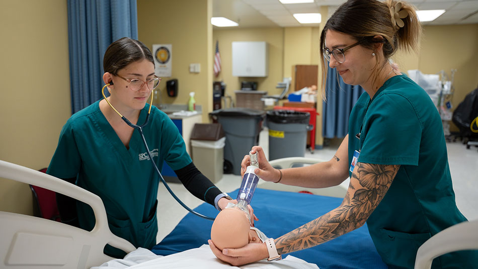 two female Cardiopulmonary Science students practicing their respiratory care skills