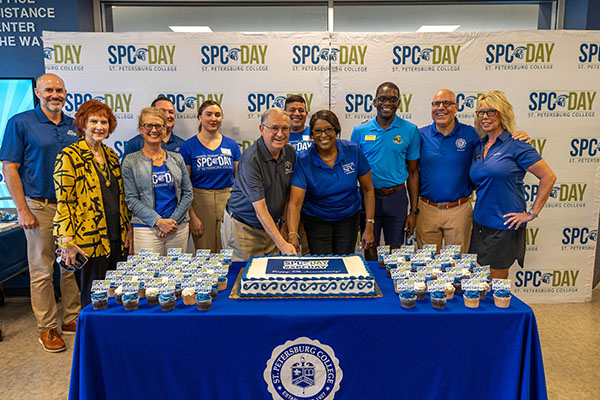 SPC officials and partners cutting a large cake during SPC Day on the Seminole Campus