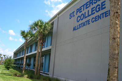 SPC Allstate center building from an angle, under blue skies and behind a row of palm trees.