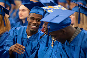 group of graduates wearing blue cap and gown