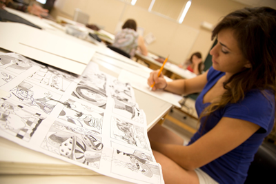 a student working at a drawing table.